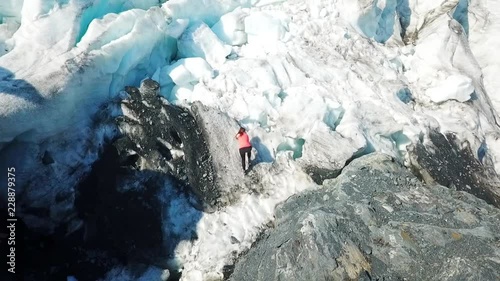 Aerial View Woman Climbing Foot of Glacier photo