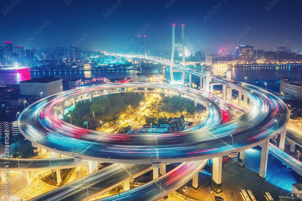 Scenic view on famous bridge in Shanghai, China at night. Multicolored nighttime skyline. Travel background.