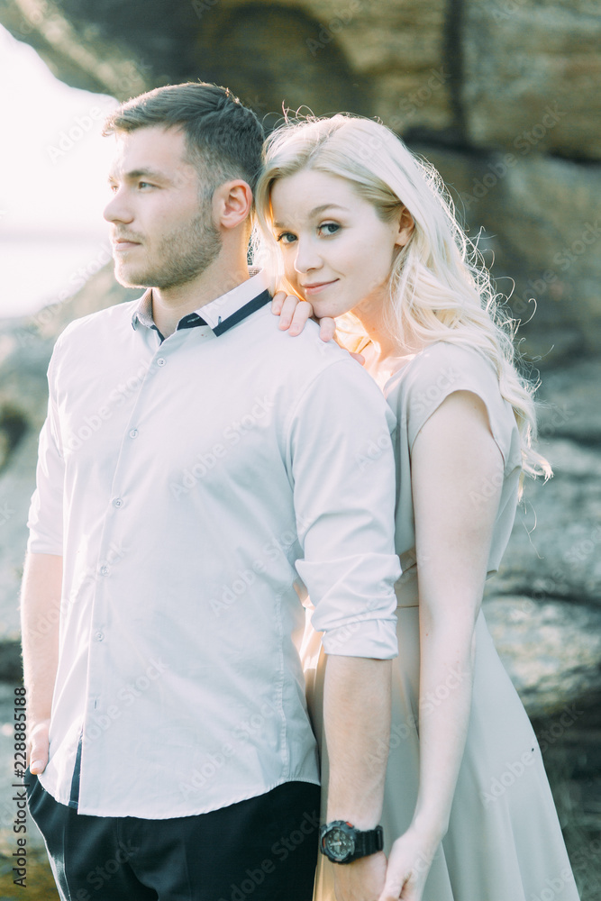 Wedding couple on a walk, photo shoot in the mountains. Fine art style in the decor. A stylish young model