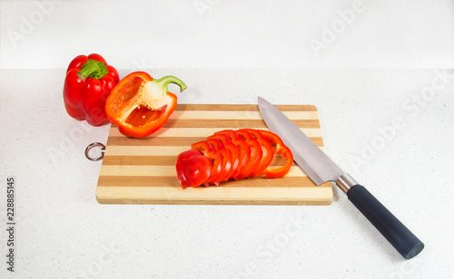 Bulgarian pepper on a cutting Board with a knife. photo