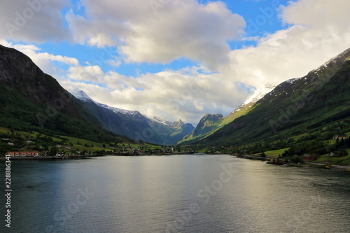 A color image of the Norwegian seascape and mountainside as seen from the balcony of a cruise ship while on a holiday cruise in Norway.