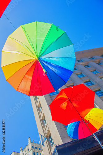 multicolored umbrella ornament flying in a city - sky
