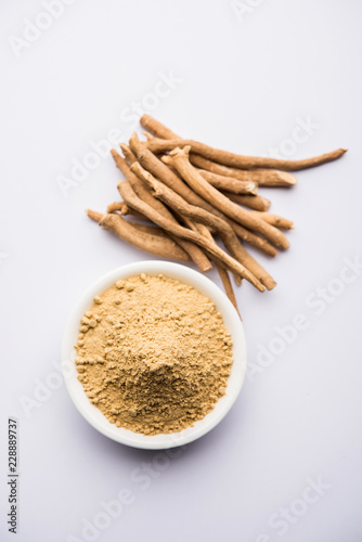 Ashwagandha / Aswaganda OR Indian Ginseng is an Ayurveda medicine in stem and powder form. Isolated on plain background. selective focus © Arundhati