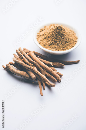 Ashwagandha / Aswaganda OR Indian Ginseng is an Ayurveda medicine in stem and powder form. Isolated on plain background. selective focus