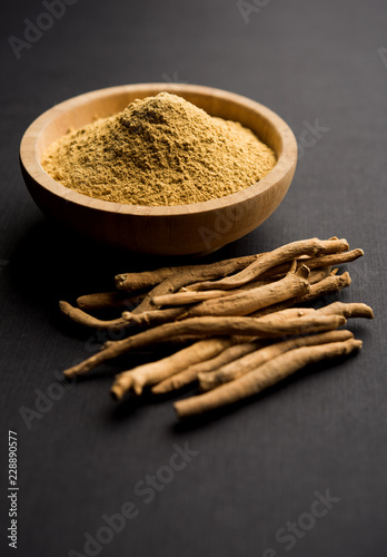 Ashwagandha / Aswaganda OR Indian Ginseng is an Ayurveda medicine in stem and powder form. Isolated on plain background. selective focus