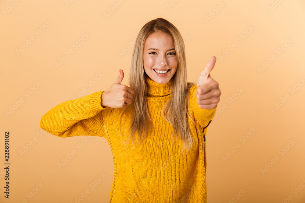 Portrait of a cheerful young woman dressed in sweater Portrait of a cheerful young woman dressed in sweater