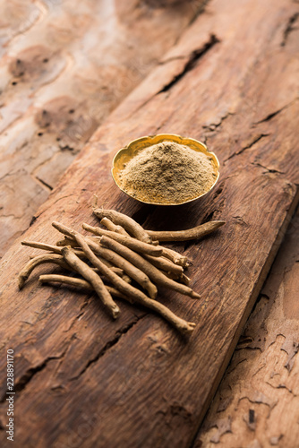 Ashwagandha / Aswaganda OR Indian Ginseng is an Ayurveda medicine in stem and powder form. Isolated on plain background. selective focus