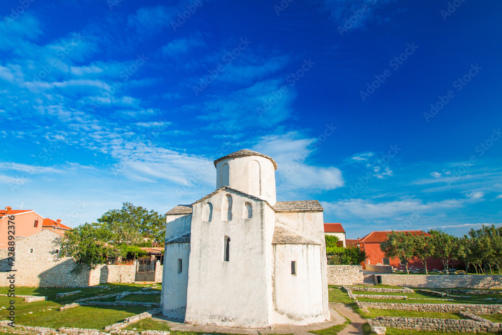 Croatia, Dalmatia, Nin, medieval church of Holy Cross from 9th century and archaeological site in historic center of town of Nin, summer day, urban landscape
