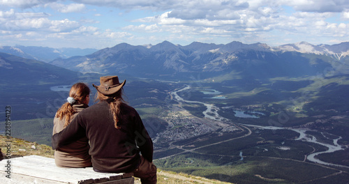 Tourists enjoy the panoramic view of the Jasper townsite and the canadian rockys from above the upper tram station. Jasper, Alberta, canada photo