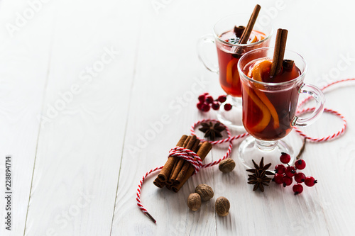 Two glass of mulled wine on the white wooden table