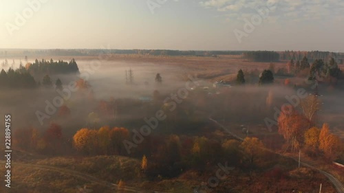Flight in early foggy morning outside the city in Russia