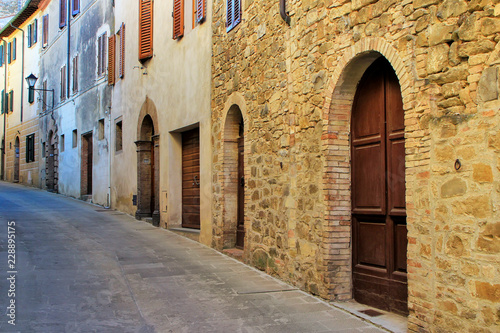 Narrow street in historic center of  Montalcino town, Val d'Orcia, Tuscany, Italy © donyanedomam
