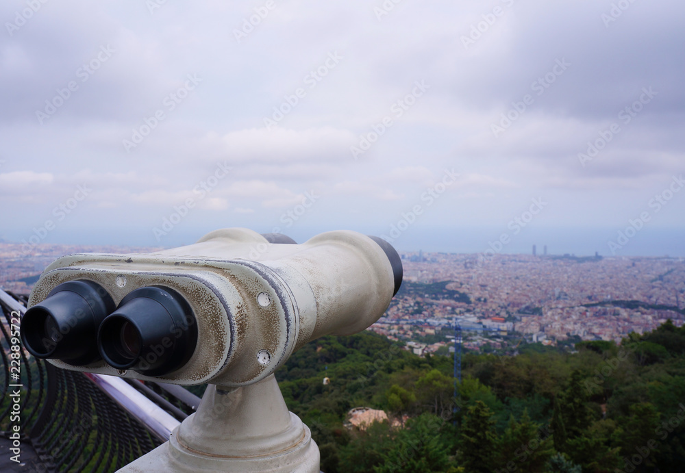 Stationary binoculars on the viewing platform Tibidabo, cityscape of Barcelona, Spain