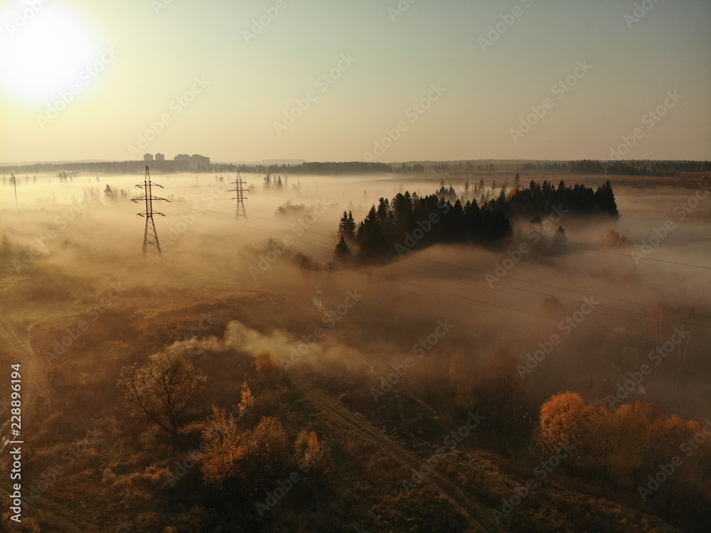 Suburban Foggy landscape with power lines in Russia.