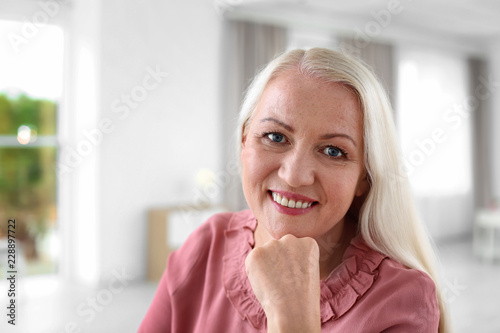 Portrait of beautiful older woman against blurred background