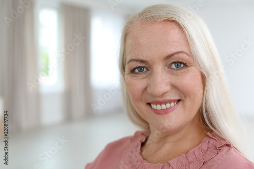 Portrait of beautiful older woman against blurred background with space for text Free Download Portrait of beautiful older woman against blurred background with space for text - GFXLoad