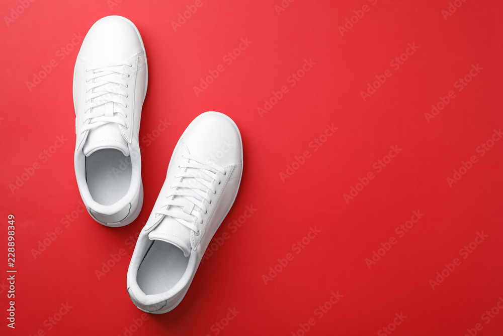 Pair of sneakers on color background, flat lay. Space for text - obrazy, fototapety, plakaty 