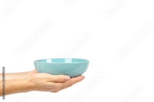 Blue empty ceramic bowl with hand isolated on white background, copy space template