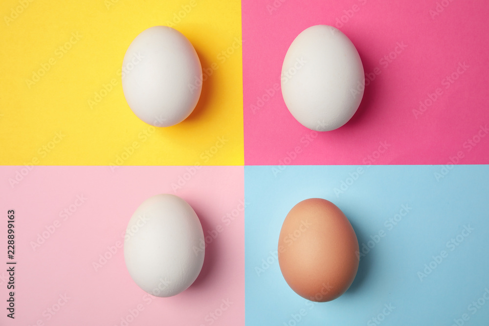 Raw chicken eggs on color background, top view Raw chicken eggs on color background, top view