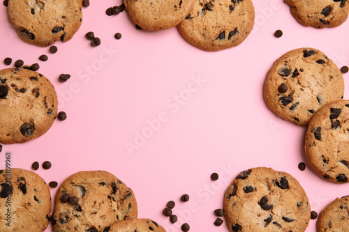 Delicious chocolate chip cookies on color background, flat lay. Space for text