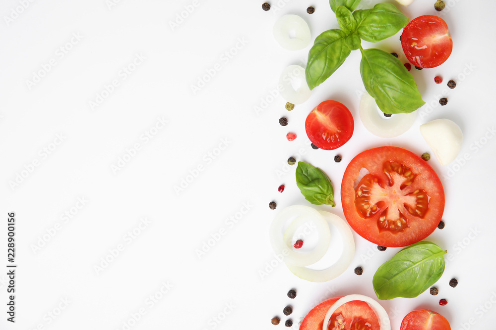 Fresh green basil leaves, tomatoes and mozzarella on white background, top view Fresh green basil leaves, tomatoes and mozzarella on white background, top view