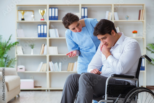 Disabled patient on wheelchair visiting doctor for regular check © Elnur