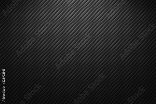 Fototapete Vector carbon fiber texture. Dark background with lighting.