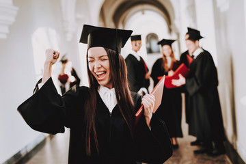 Robes. Graduate. Asian Girl. Cheerful. Standing.