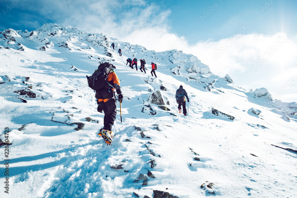 A group of climbers ascending a mountain in winter