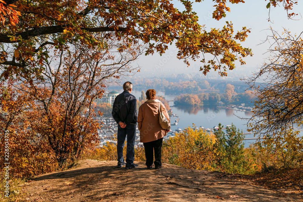 elderly couple in love looks at the view of the river and islands elderly couple in love looks at the view of the river and islands
