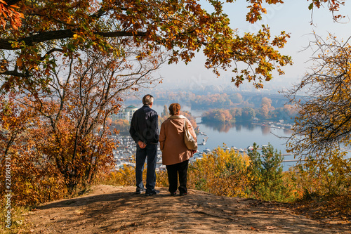 elderly couple in love looks at the view of the river and islands