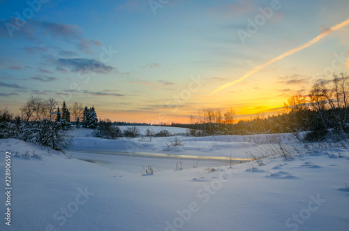Frosty winter landscape with frozen ice bound river. © valeriy boyarskiy
