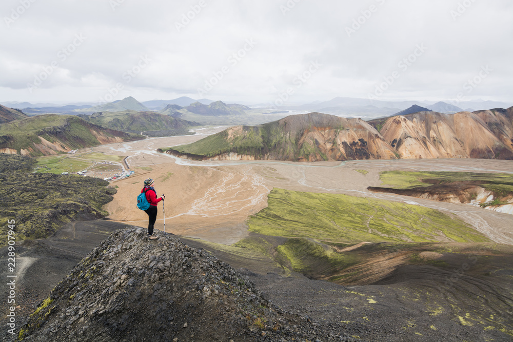 Woman hiking in the colourful mountains of Landmannalaugar national park, Iceland