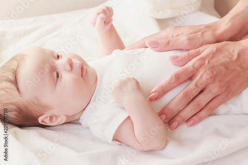 Baby and hands of mother, soft focus background