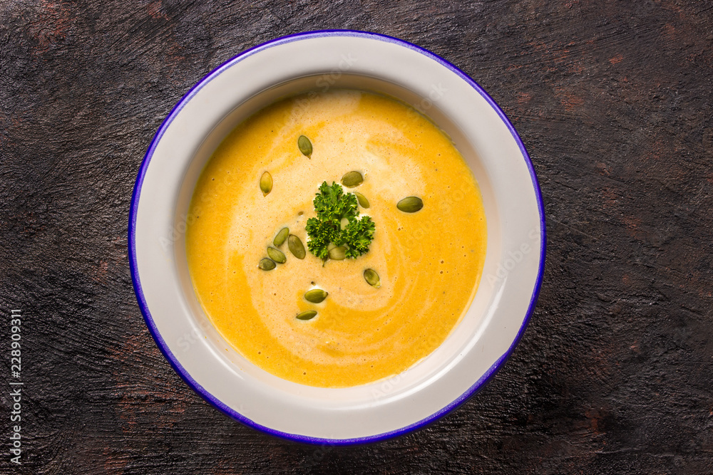 Seasonal autumn food - Spicy pumpkin soup with cream and pumpkin seeds. Seasonal autumn food - Spicy pumpkin soup with cream and pumpkin seeds.