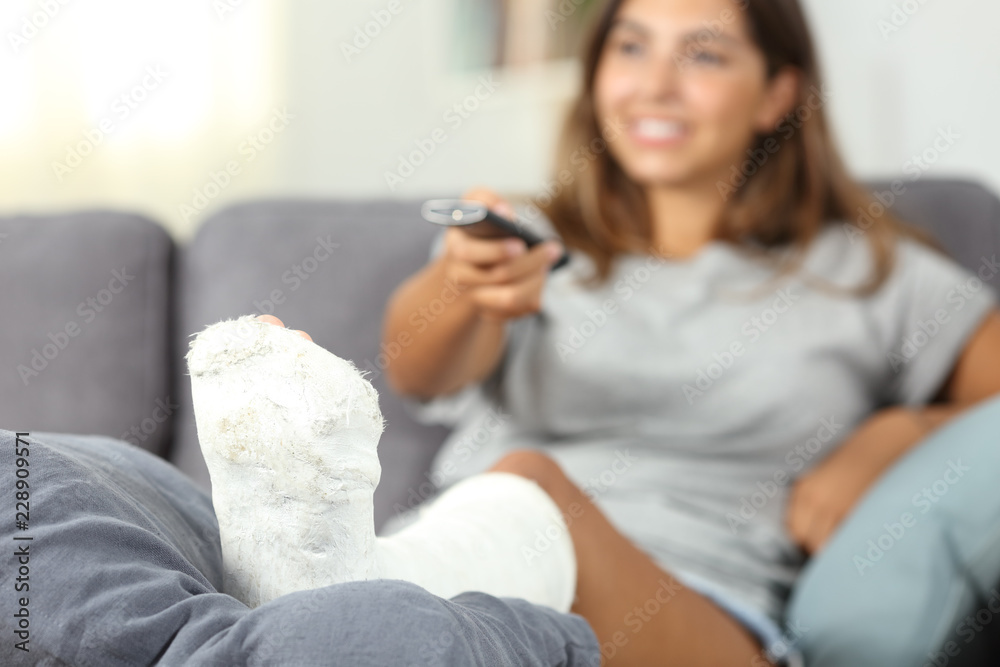 Disabled happy woman watching tv at home Disabled happy woman watching tv at home