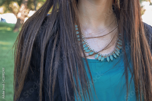 Long haired girl with syntetic gems necklace photo