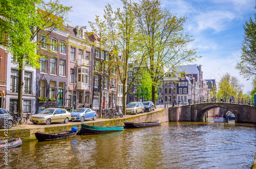 Traditional old buildings and and boats in Amsterdam  Netherlands. Canals of Amsterdam.