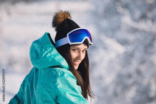 Woman snowboarder portrait at snowy day