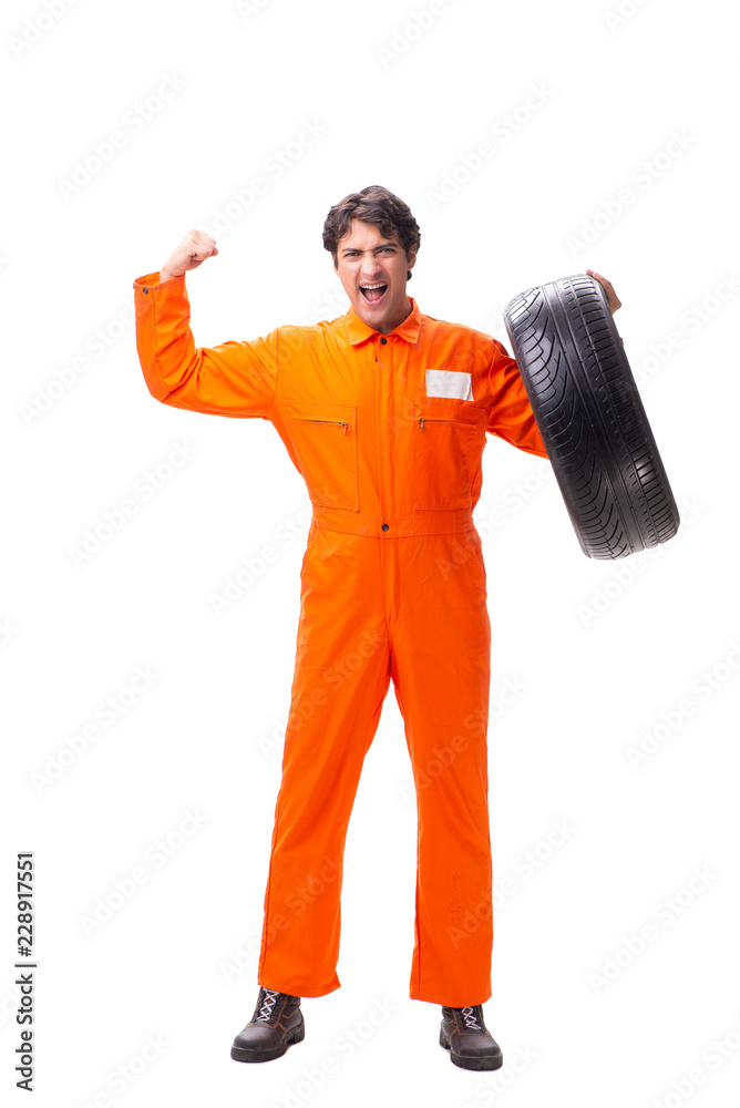 Young garage worker with tyre isolated on white Young garage worker with tyre isolated on white