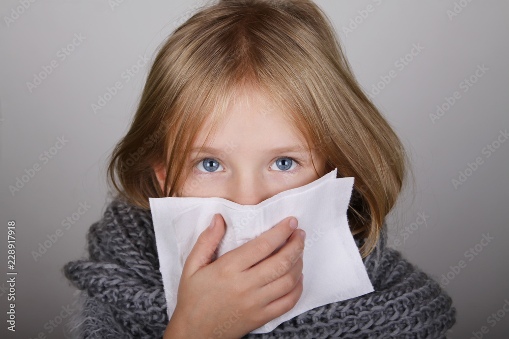 cute blond hair little girl blowing her nose with paper tissue. Child winter flu allergy health care concept cute blond hair little girl blowing her nose with paper tissue. Child winter flu allergy health care concept