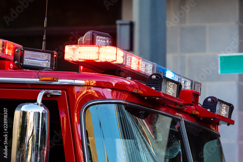 Firefighter truck up close with sirens and flash lights blinking.