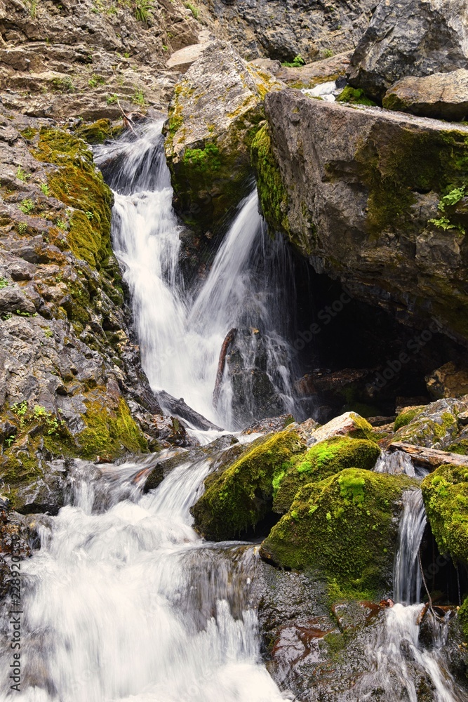 Fototapeta premium Waterfall and river stream Mountain views from hiking trails to Doughnut Falls in Big Cottonwood Canyon, in the Wasatch front Rocky Mountains, Utah, Western USA.