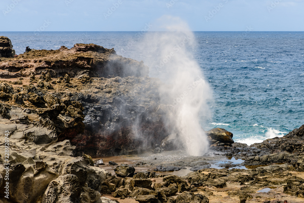 Nakalele Blowhole shots water into the air  in Maui, Hawaii