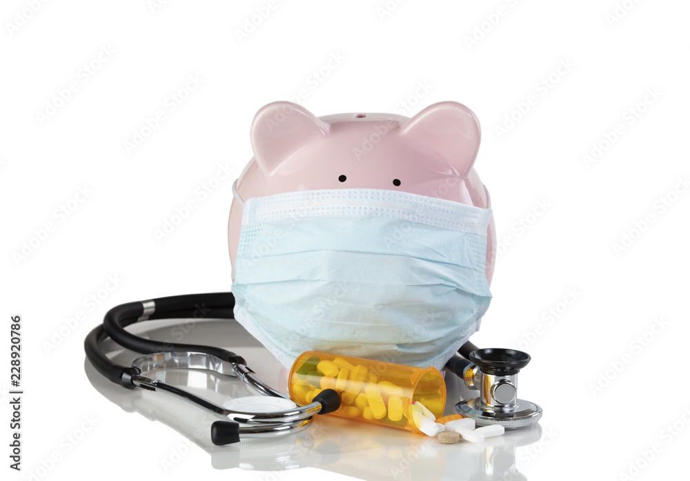 Piggy bank wearing surgical mask with medical drug supplies isolated on a white background Piggy bank wearing surgical mask with medical drug supplies isolated on a white background