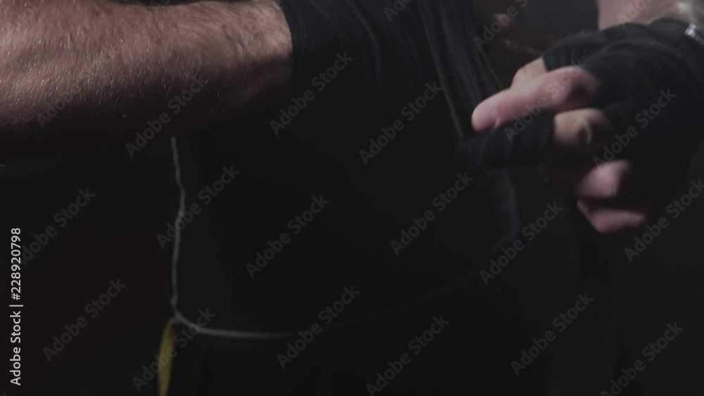 Man Boxer Wrapping Hands. Young Athlete Getting Ready for Fight. Man Boxer Wrapping Hands. Young Athlete Getting Ready for Fight.