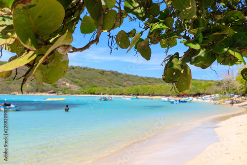 Fototapeta Naklejka Na Ścianę i Meble -  Caribbean beach with fishing boats at Playa la Ensenada, Dominican Republic