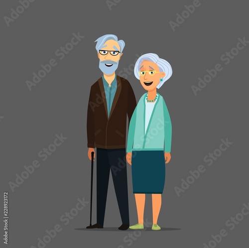 Old senior man and woman in glasses standing or walking together arm in arm. Aged grey haired couple.