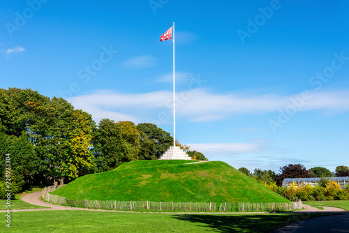 The Mound (artificial hill) wiith a tall flagpole in Duthie Park, Aberdeen, Scotland