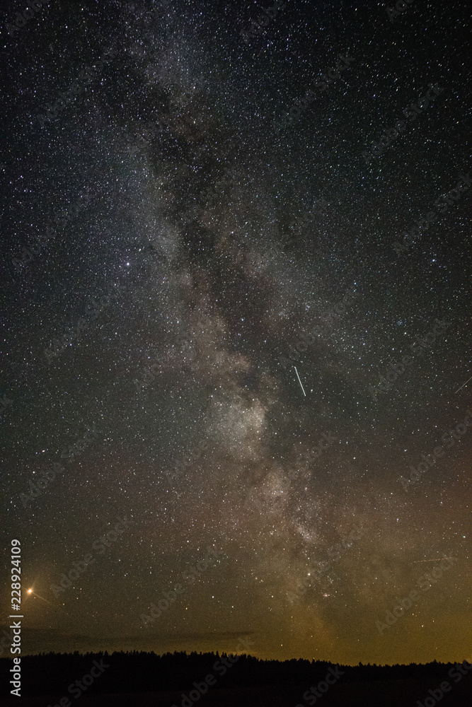 Bright milky way on a summer night through the clouds Bright milky way on a summer night through the clouds